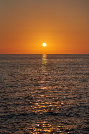 A vertical of the sunset over a tranquil sea at Belvedere Marittimo, Cosenza, Calabria, Italy
