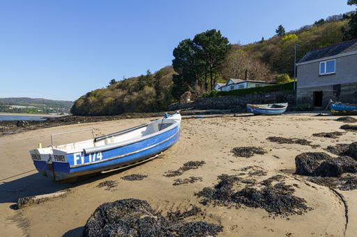 shoreline Conway north Wales UK sandy beach with small wooden  rowing boat