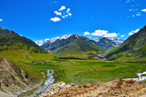 The mesmerizing views of the green landscapes and a river against the cloudy sky in spring