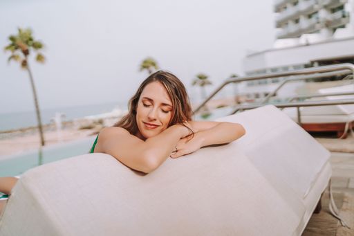 A beautiful young woman relaxing at a tropical resort