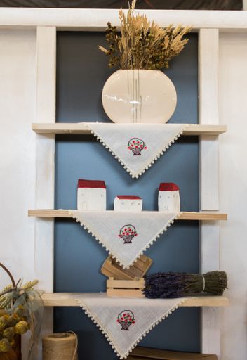 A vertical shot of wooden shelves on the wall with various decorations