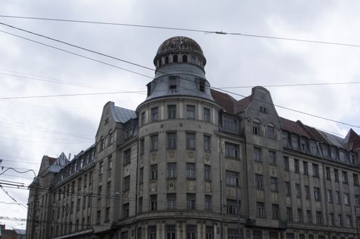 A low angle shot of a building's facade under a cloudy sky