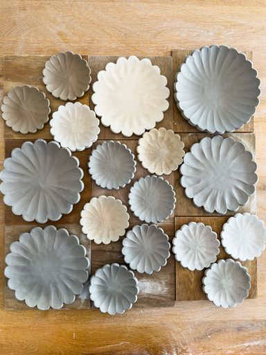 Ceramic plates and bowls drying before being bisque fired