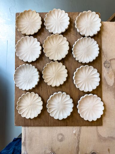 Ceramic plates and bowls drying before being bisque fired