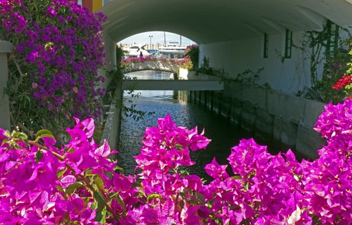 Canal going under houses and typical of this town, Playa de Mogan, Gran Canaria, Spain.