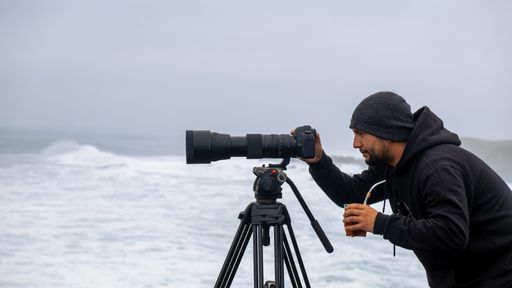 surf photographer, taking photos with his telephoto on a cloudy day in Chile, with Argentine mate drink