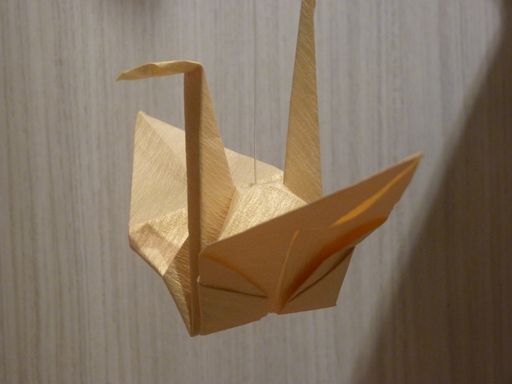 A closeup shot of an origami on a gray background