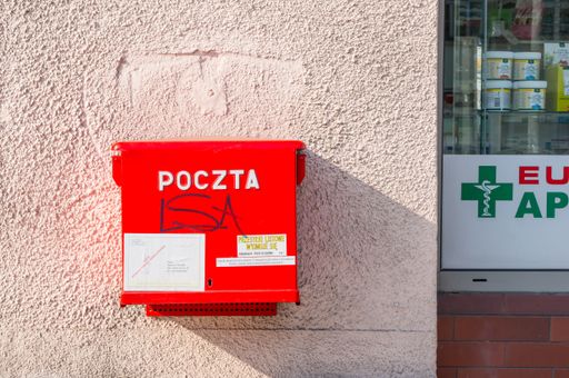 Red mail box hanging on a wall