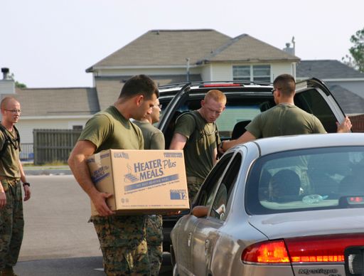 Air Force Personnel load emergency supplies into civilian cars. Relief for Hurricane Katrina.