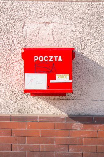 Red mail box hanging on a wall