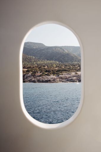 A vertical of the sea seen from a white boat on a sunny day in Akamas, Cyprus