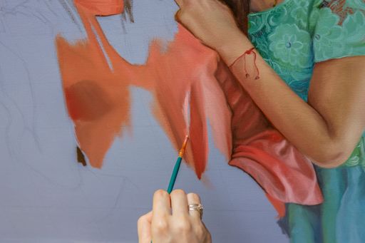 A part of the beautiful painting with oil paints and artist's hand with a paintbrush