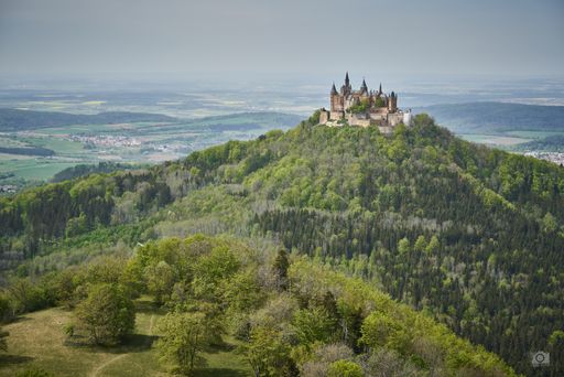 An aerial shot of the Hohenzollern castle and beautiful nature in Germany in summer