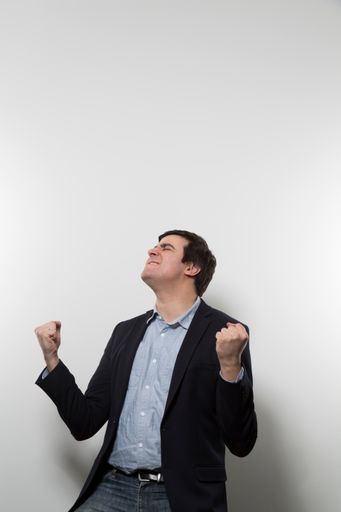 A vertical shot of a happy businessman cheering - great for a commercial