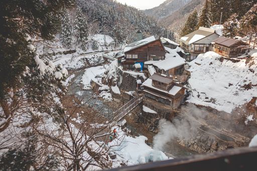 A wooden building on the cliff covered in snow in the winter