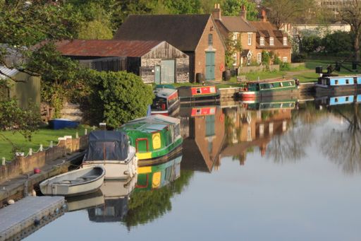 A beautiful shot of a canal with boats near the buildings