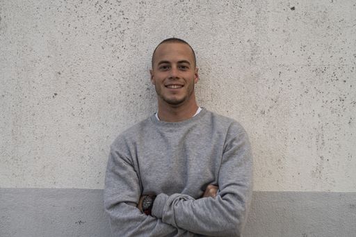 A  handsome young man smiling and looking at the camera