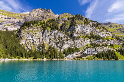 A majestic view of mountain lush peaks and the Oeschinensee lake in Switzerland
