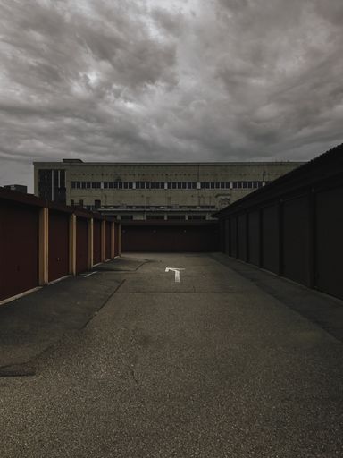 A vertical shot of front view of an abandoned building in Lugano against gloomy sky