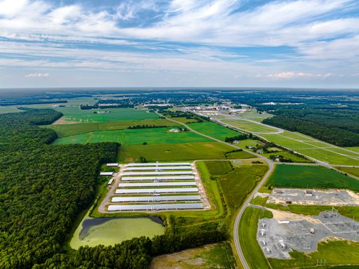 Aerial view of lush green farmland in Delaware during the summer season, captured from a high angle
