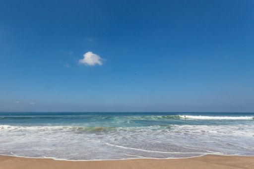 A stunning beach scene in Legian, Bali, Indonesia on a sunny day