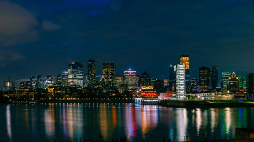 Aerial view of the vibrant city of Montreal, Canada at night, showcasing the illuminated downtown skyline and its iconic landmarks