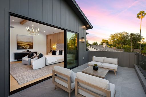 A contemporary abode featuring up to date furnishings and ample windows on a spacious porch