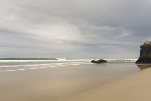 A vertical shot of the beach in the Province of Galicia, Spain during daylight