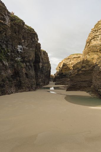 A vertical shot of the beach in the Province of Galicia, Spain during daylight