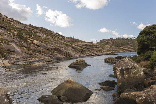 A beautiful shot of a stream flowing on the middle of rock formations in Galicia, Spain