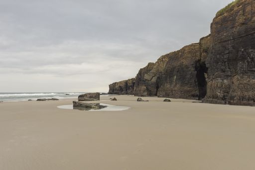 A closeup shot of a big rock on the seashore in the Galicia, Spain