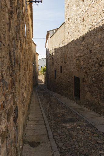 The alley between stone buildings in the medieval city of Caceres, Extremadura, Spain