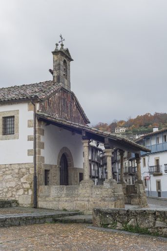 A vertical shot of the Hermitage of Cristo del Refugio under a cloudy sky in Candelario, Spain