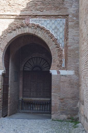 a vertical shot of an arched entrance ine Alhambra of Granada Andalucia Spain