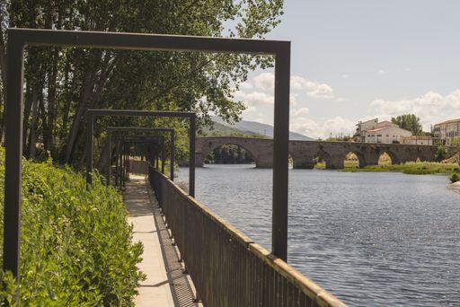 a path along the river with a bridge in Barco Avila Castilla la Mancha Spain