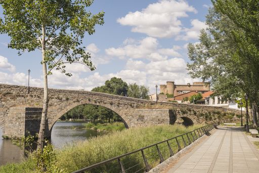 a bridge over the river and a paved path along the river in Barco Avila Castilla la Mancha Spain