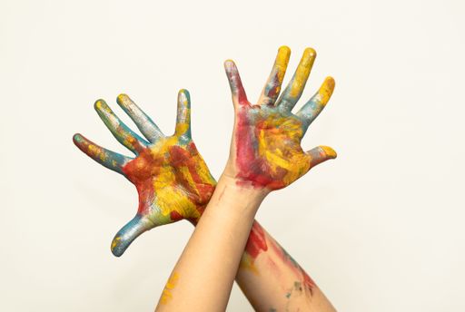 A closeup shot of two painted hands in front of a clear background