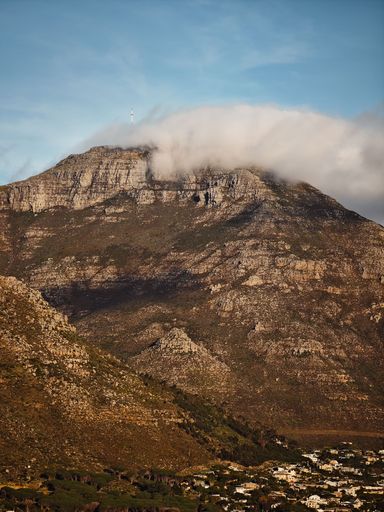 A majestic mountain peak surrounded by white clouds in South Africa