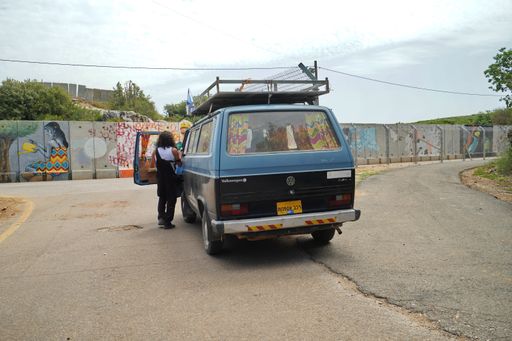 old blue vw transit van on Israel Lebanese border by graffiti wall