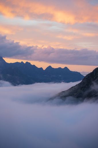 A vertical shot of sunset clouds over the Alps in Switzerland