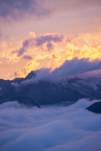A vertical shot of sunset clouds over the Alps in Switzerland