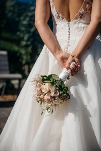 A bride holding white bouquet on her wedding day