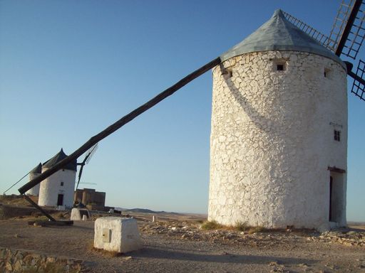 The Molinos de Viento de Consuegra on a beach under the sunlight in Toledo, Spain