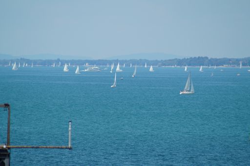 A beautiful shot of sailing boats with mountain on the background