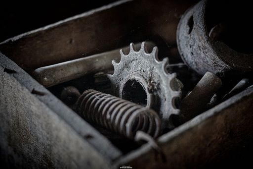 A metal box containing various gears and tools