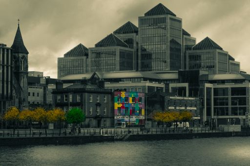 A modern multi-colored building, with various hues of blue, yellow, green and red adorning its exterior walls