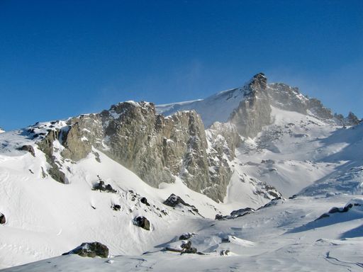 Th majestic snow-covered mountain peaks, rising up into the sky and providing a breathtaking view