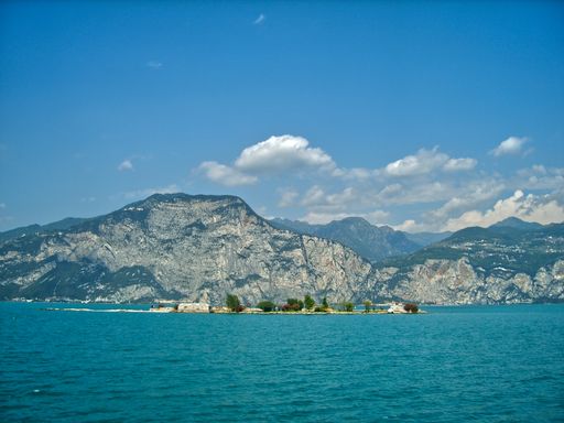 A stunning view of the Lake Garda with crystal clear water in Italy under a beautiful blue sky