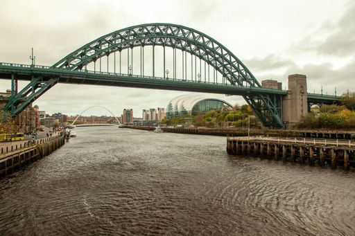 A beautiful shot of Tyne Bridge running over a river in Newcastle, UK