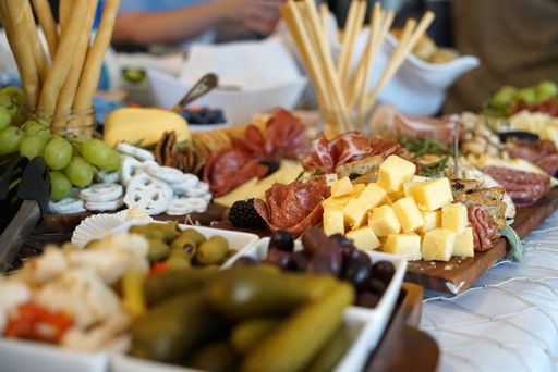 A delicious looking charcuterie board with a variety of gourmet cheeses, meats, and olives
